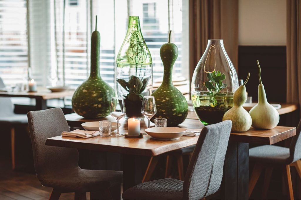 Rode Rondvaartboot 'Dordrecht' Met Passagiers Op Een Gracht Langs Historische Gevelpanden Gedekte Restauranttafel Met Groene Siervazen En Kalebassen Grijze Stoelen Kaars En Daglicht Door De Jaloezieën